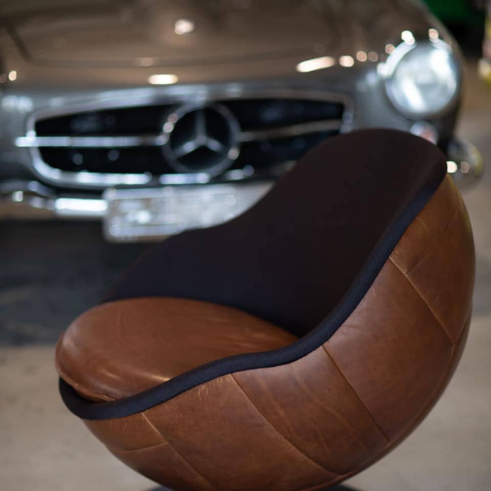 image of retro football chair vintage football chair in front of classic car Hot Rods wembley lillus by lento lounge chair retro leather dark brown retro interior design nostalgic style oft he 60-s